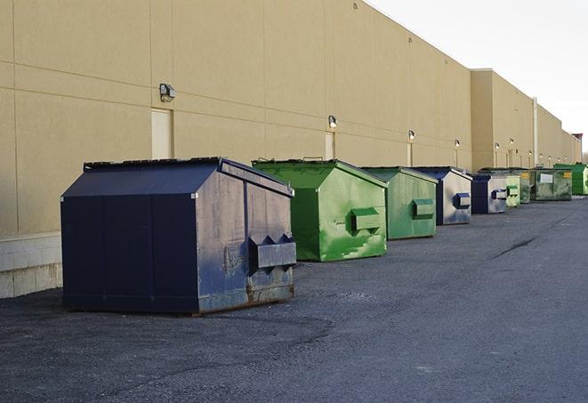 a crowd of dumpsters of all colors and sizes at a construction site in Allegan, MI